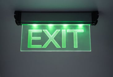 A well lit and prominently displayed exit sign that is an integral part of a buildings well maintained emergency lighting system